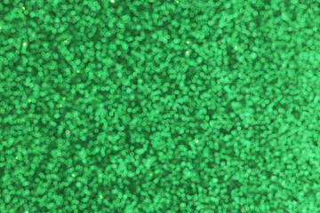 Green blurred shiny background. Color in trend. Colour. Sequins.