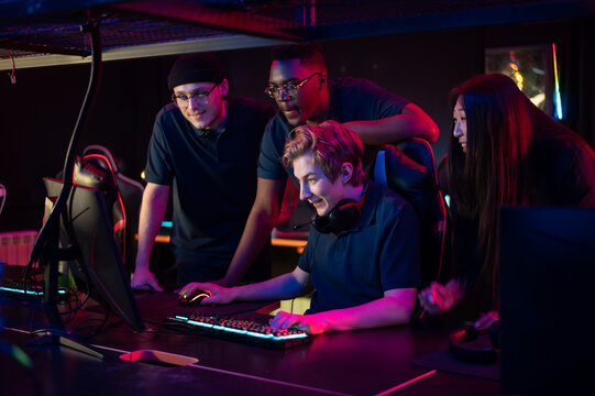 Players of the esports team gathered together in the computer club and watch the stream from the dota 2 world championship