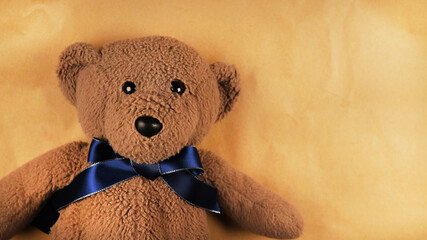 teddy bear on a brown background. Children's soft toy bear.