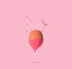 2021 Easter unique concept with bunny rabbit ears on pink background. Creative still life composition.