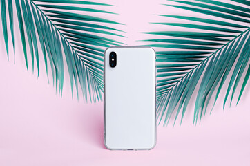 iPhone X clear case mockup, smart phone back view isolated on pink background with palm leaf