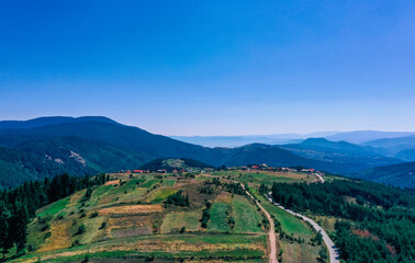 Fototapeta premium Village in a mountain landscape. Europe, Bulgaria, Bansko. Ski resort city panoramic view. 