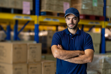 Confident male warehouse worker standing with arms crossed in factory warehouse near of products or parcel goods background. Inspection quality control - obrazy, fototapety, plakaty