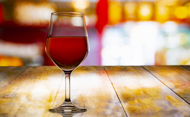 goblet of wine on the wooden table of a restaurant