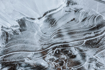 The texture of the thin ice on the water surface