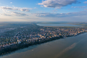 Aerial view of Galati City, Romania. Danube River near city with sunset warm light