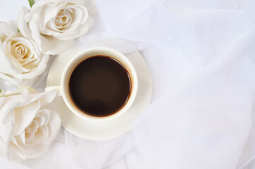 cup of coffee with white roses in the morning