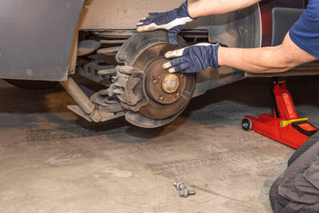 Close up view of how a man checks brake discs on a car. Transportation concept. Sweden.