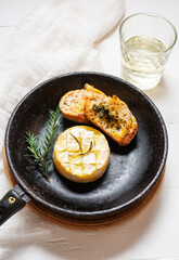 Delicious beautiful baked camembert with honey, walnuts, herbs and cranberries
