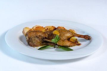 Fried chicken legs and potatoes with a green sprig