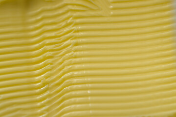 Super macro horizontal lines in margarine, made by a serrated knife.