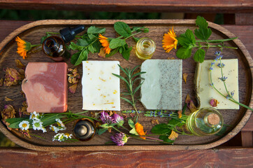 Naklejka na ściany i meble Top view of natural handmade skincare. Organic soap bars with plants extracts and oil bottles