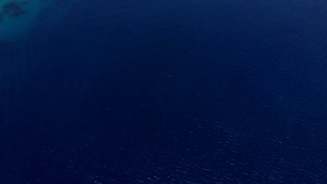 Flying over and close to the sea water.