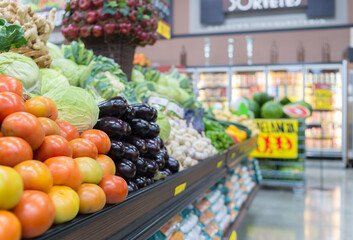 Vegetable farmer market counter: colorful various fresh organic healthy vegetables at grocery store. Healthy natural food concept Supermarket aisle with empty shopping cart fresh vegetables