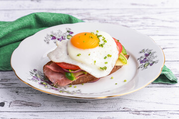 Farmer's toast with fresh cheese, fried egg, red onion, green pepper, tomato and ham