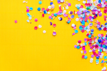 confetti on yellow background, colored background 