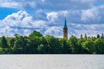 Fototapeta na wymiar Church on lake in Poland summer