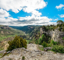 Fototapeta na wymiar River and canyon between mountains with blue sky with clouds at Zaorejas viewpoint in Guadalajara, Spain