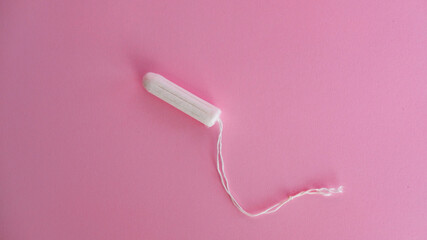 white tampon on pink background menstrual product woman blood vaginal