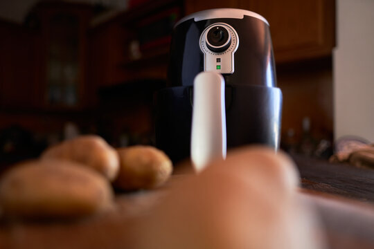 Cooking potatoes sticks with spices in an air fryer