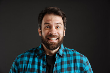 Bearded excited white man smiling and looking at camera