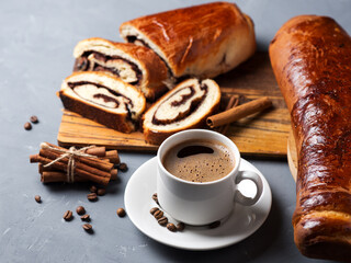 homemade pastries a poppy seed bun, a cup of coffee on the table