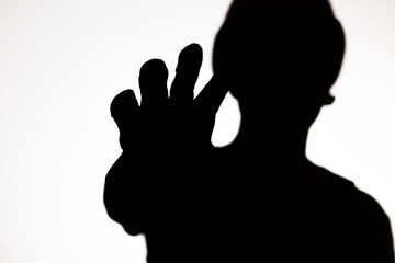 silhouette of builder in hard hat showing palm forbidding gesture stop, warning hand sign,workers protest