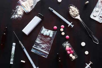 hard drugs, syringe, heroin on dark background with red glow concept of danger stop addiction drug trafficking