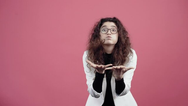 The distracted young woman with curly hair raised her hands and asked again, she did not understand. Young hipster in white jacket and black shirt,