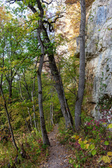 Fototapeta premium Autumn nature walks along a mountain canyon on a warm autumn day, along a difficult route.