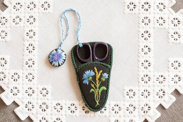 hand-embroidered scissors case on a napkin