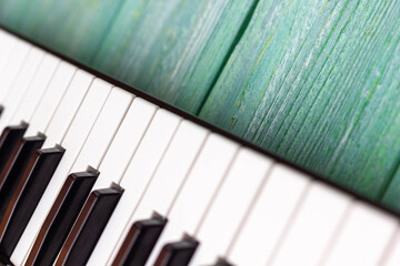 Piano keyboard on a wooden green background