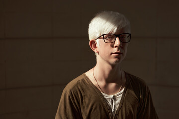Obraz premium Portrait of european albino boy wearing glasses