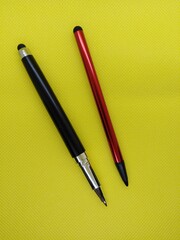 stylus pens on yellow background
