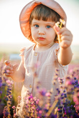 Portrait of a little beautiful girl in the rays of the sunset.