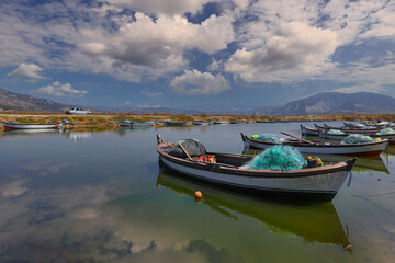 Fototapeta na wymiar (Aydın - Turkey 03.April .2021) Serçin village. Fishing boats waiting in the creek at lake bafa