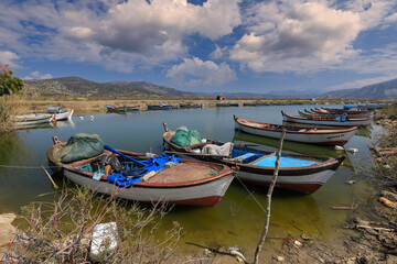 Naklejka na ściany i meble (Aydın - Turkey 03.April .2021) Serçin village. Fishing boats waiting in the creek at lake bafa