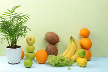 Summer tropical fruits on a bright table. Detox diet and weight loss concept, top view, healthy and natural food, source of vitamin C, banner for store, selective focus