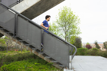 young male athlete descends stairs in a training session