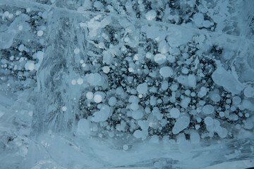 bubbles in a clear blue and frozen lake
