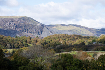 landscape view of hills, mountains and trees looking towards Blaenau Ffestiniog, North Wales with blue sky and clouds
