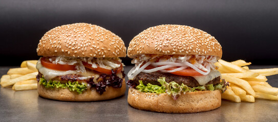 Set burgers with potatoes on the dark background