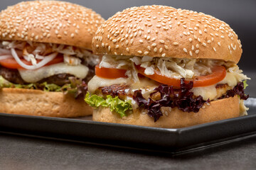 Set burgers with potatoes on the dark background