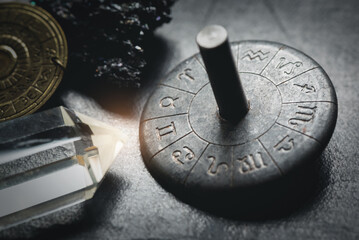 Horoscope zodiac wheel on the table close up. Gemini sign.
