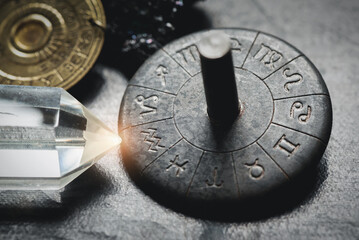 Horoscope zodiac wheel on the table close up. Aquarius sign.