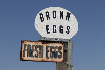 Fresh Eggs and Brown Eggs sign in front of a chicken farm.