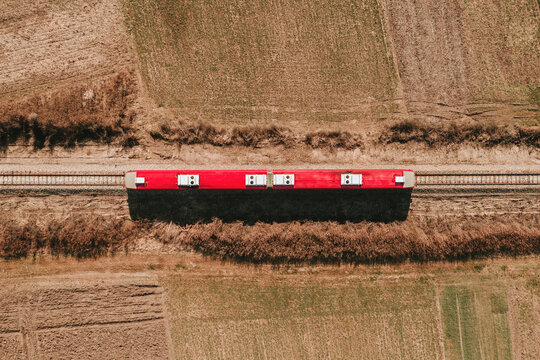 Top down aerial view of red passenger train