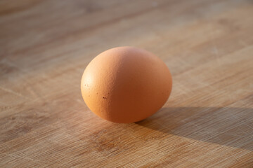 1 chicken egg and several duck eggs. One yellow egg on the table. Chicken egg on the table