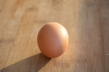 1 chicken egg and several duck eggs. One yellow egg on the table. Chicken egg on the table
