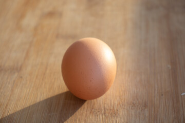 1 chicken egg and several duck eggs. One yellow egg on the table. Chicken egg on the table